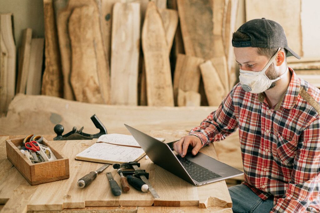 man-using-a-laptop-at-a-wood-workshop-4491881 Man Using a Laptop at a Wood Workshop